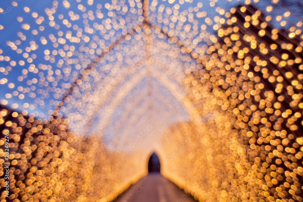 Christmas decoration. Colourful decor lights lantern tunnel in the city during winter.