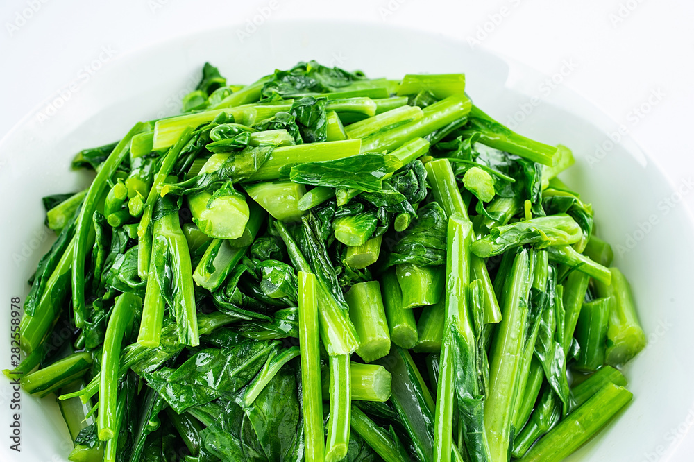 Chinese dish of fried cabbage with moss on white background