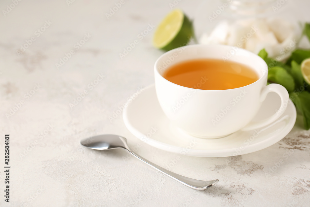 Cup of hot tea on table