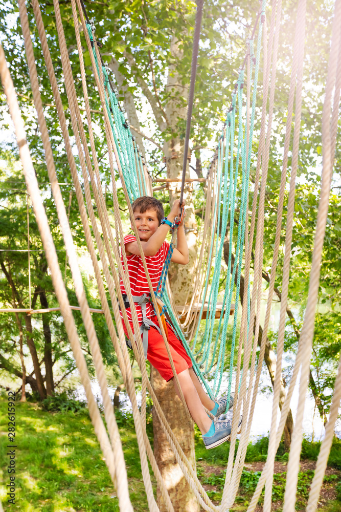 Walk from one tree to anther boy at adventure park