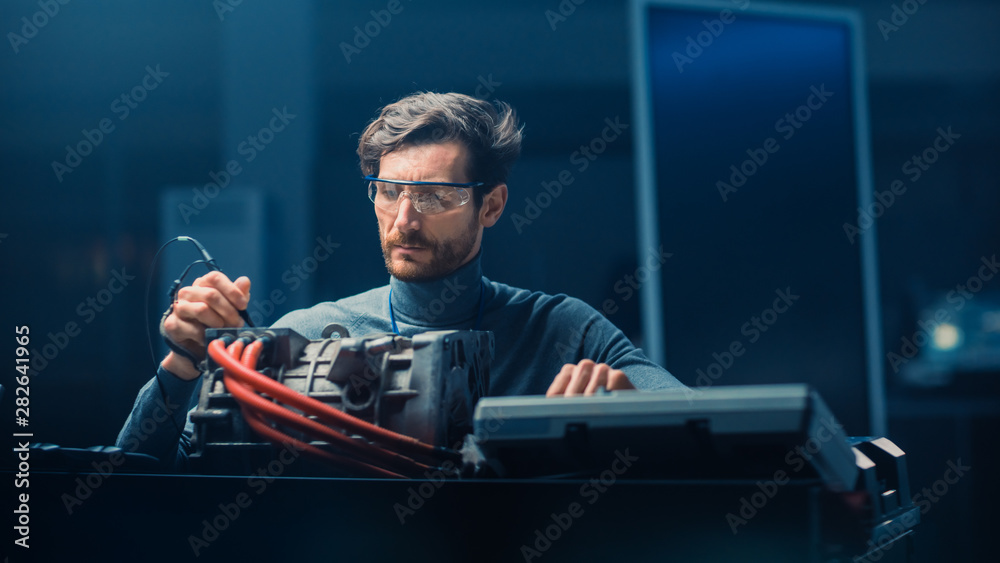 Professional Automotive Engineer in Glasses with a Computer and Inspection Tools is Testing an Used 