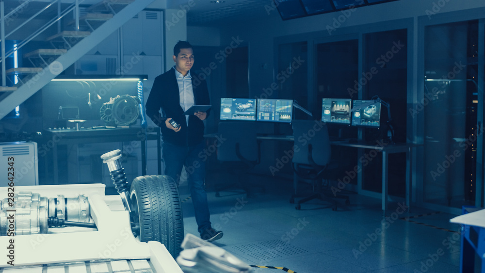 Development Laboratory Room with Professional Automotive Design Engineer Working on a Electric Car C