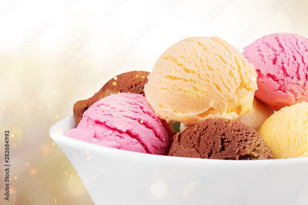 Ice cream scoops in bowl on white background