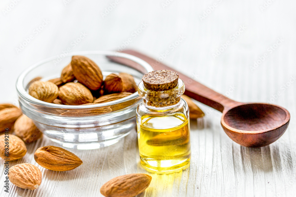 cosmetic set with almond oil on wooden table background