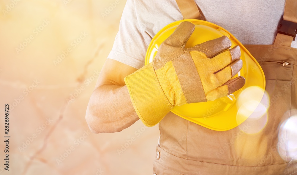 Worker man with helmet on background