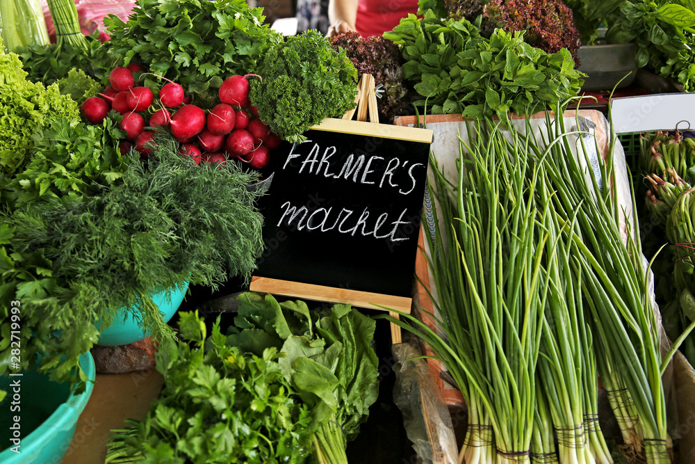 Assortment of fresh herbs on counter at farmers market