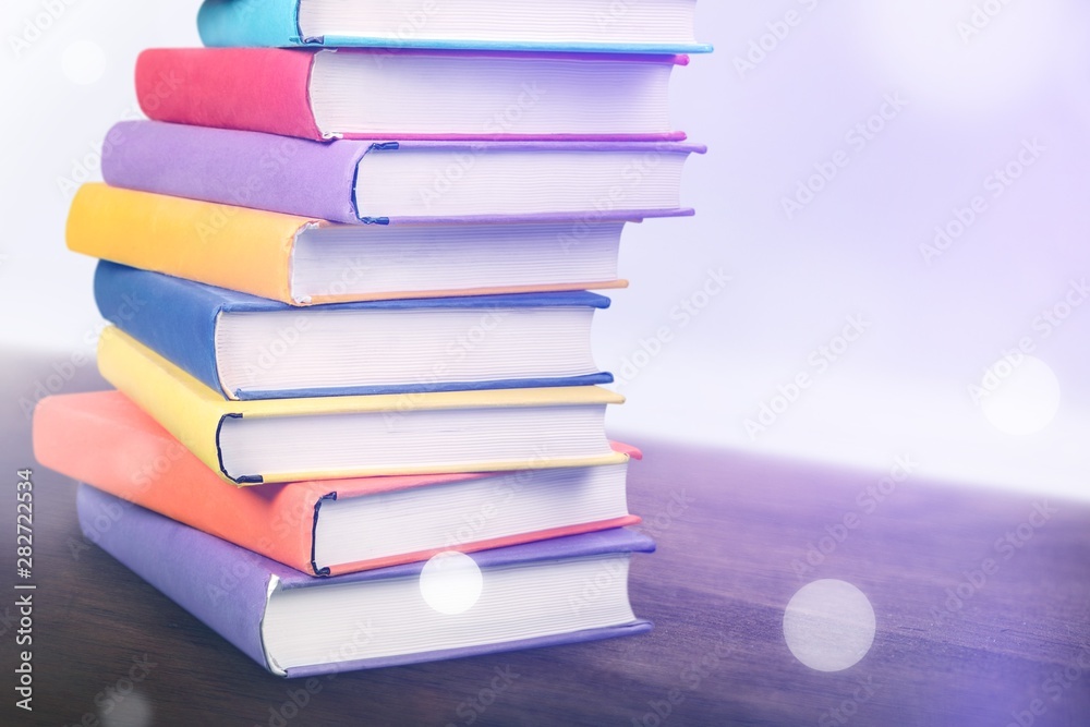 Stack books on wooden desk table