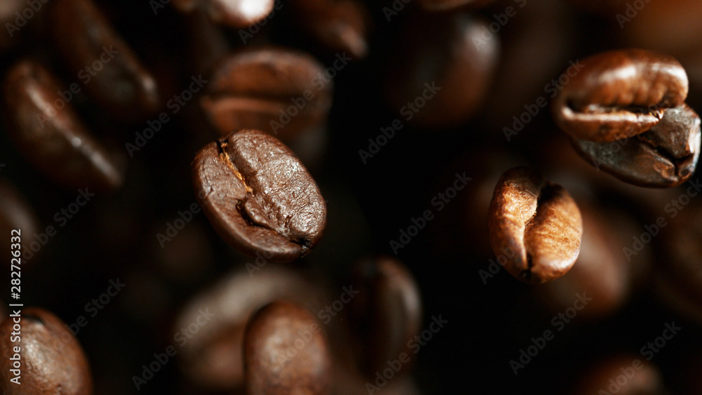 Coffee beans flying in the air, macro photo