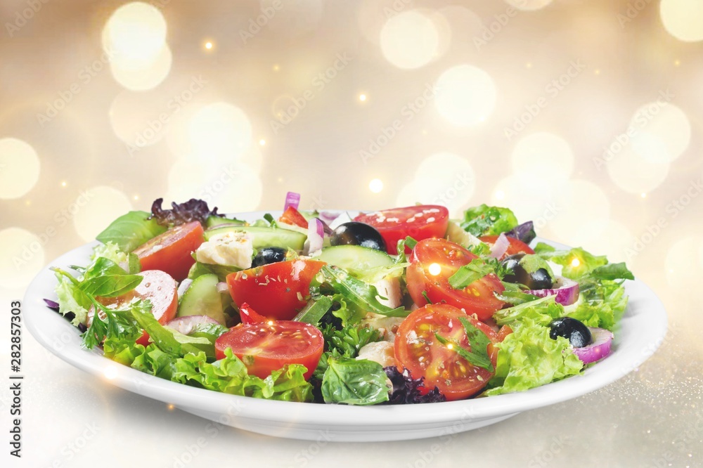 Greek salad on a multicolored background with highlights