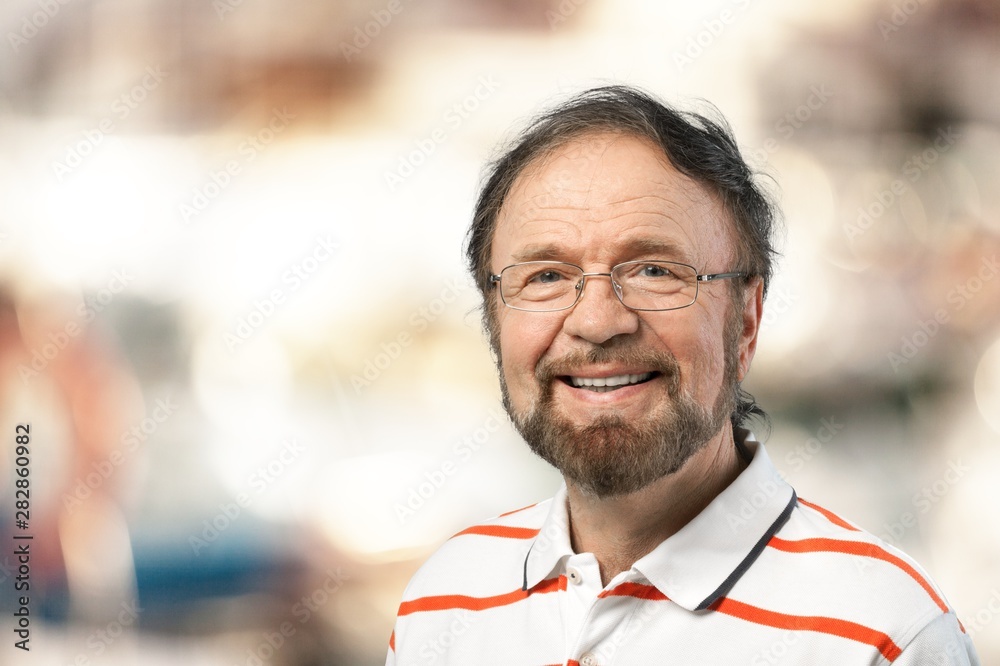 Elderly smiling man on blurred background