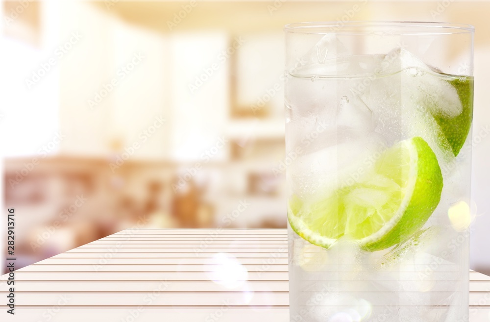 Glasses with fresh organic cucumber water on wooden table, on grey background