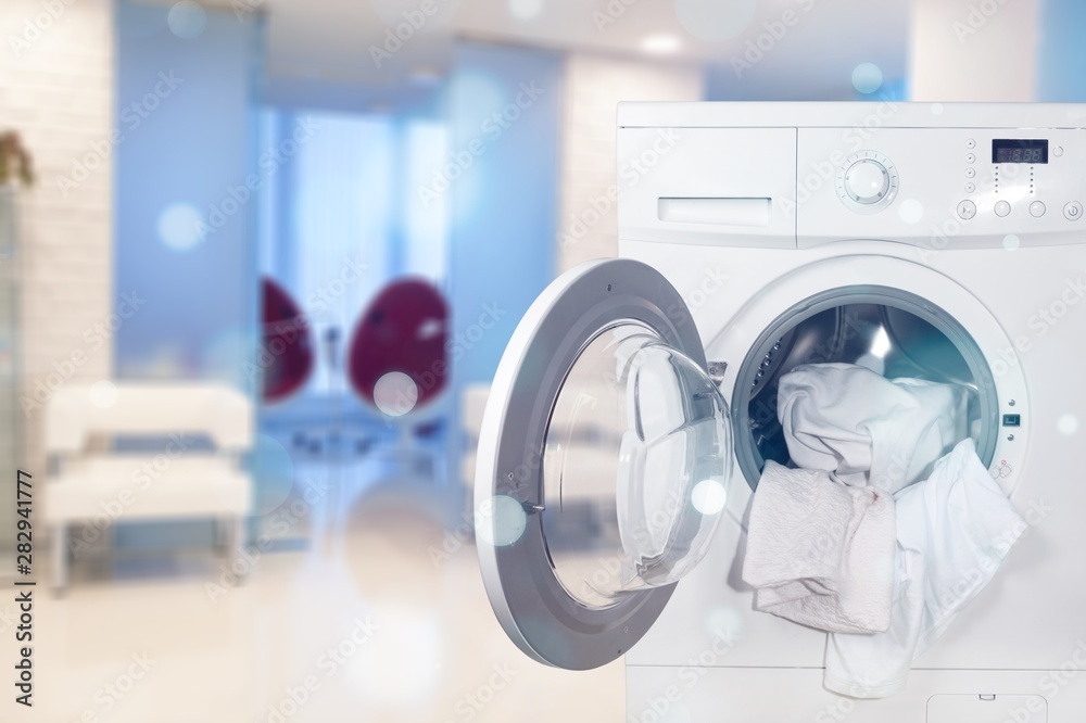 Washing machine with laundry on background