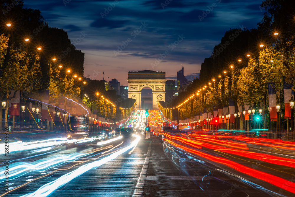 Night scence illuminations traffic street of the Impressive Arc de Triomphe Paris along the famous t