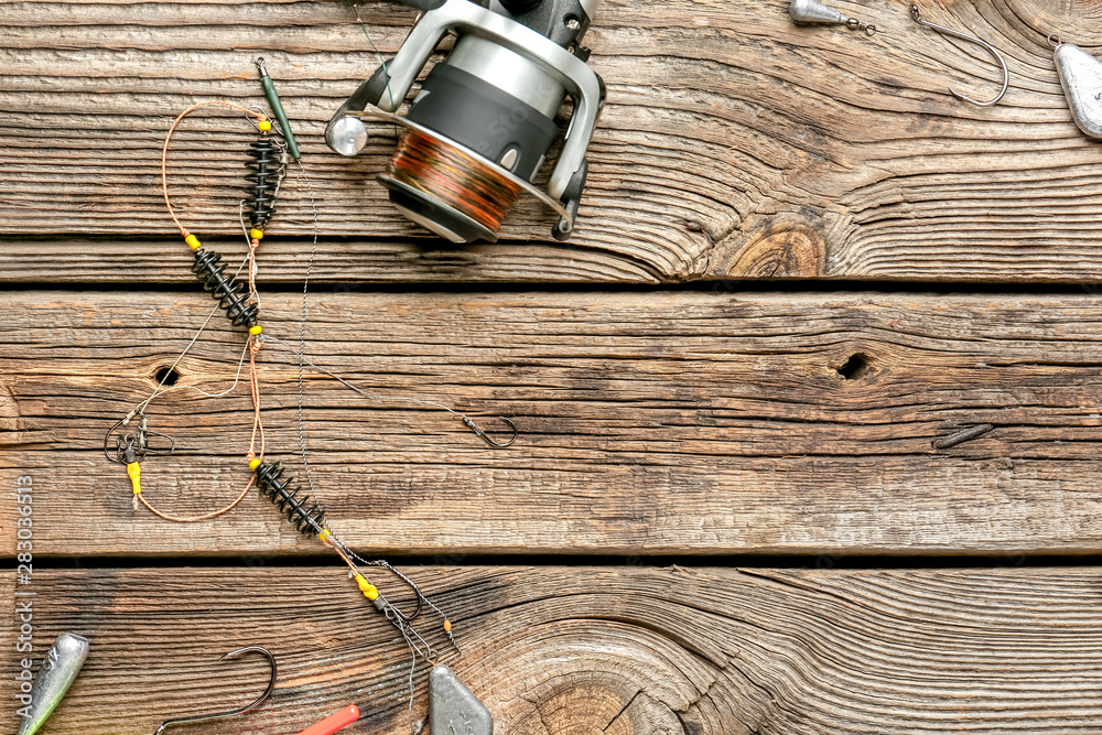 Different fishing accessories on wooden background