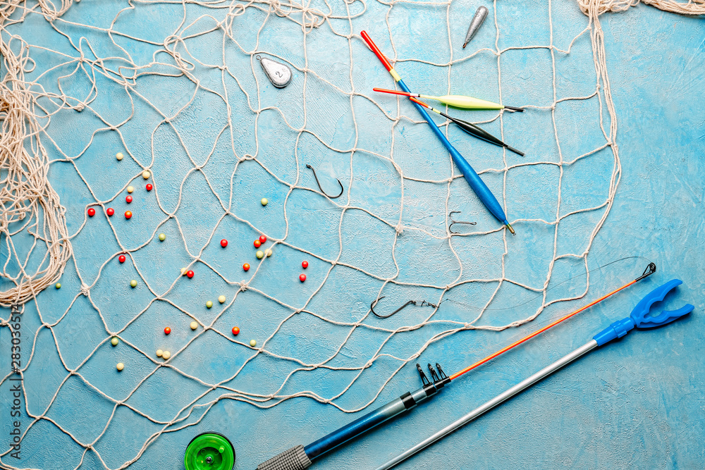 Different fishing accessories on light background