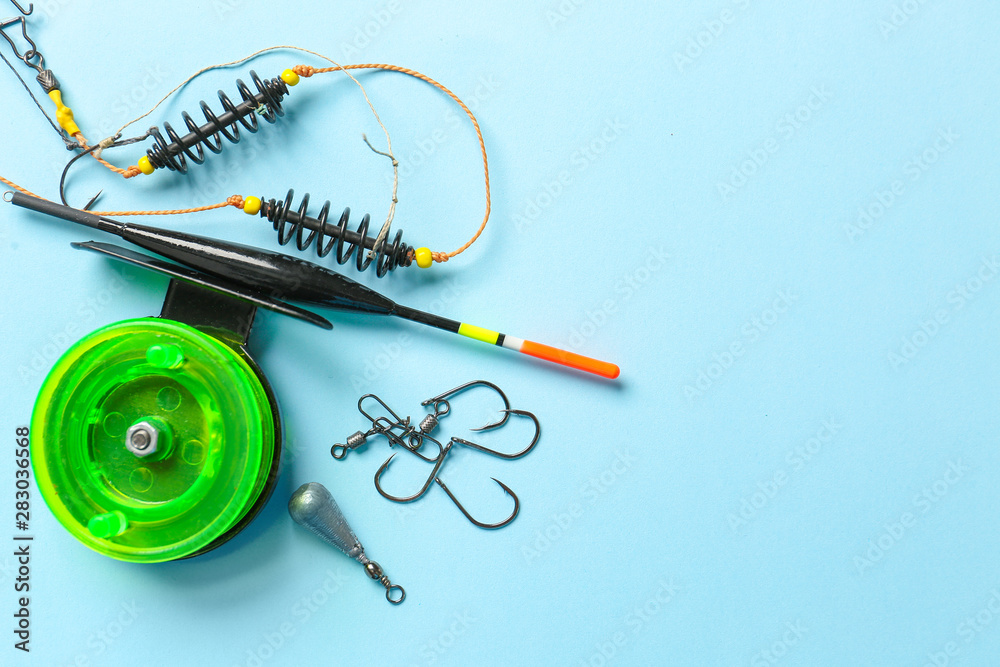 Different fishing equipment on color background