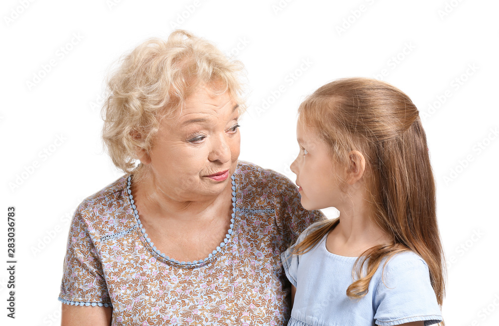 Cute little girl with grandmother on white background