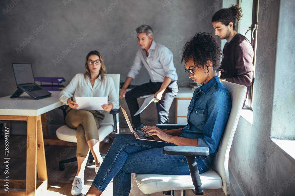 People working in a small startup office