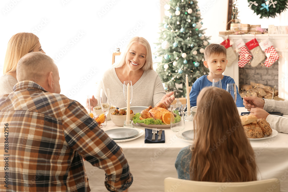 Happy family having Christmas dinner at home