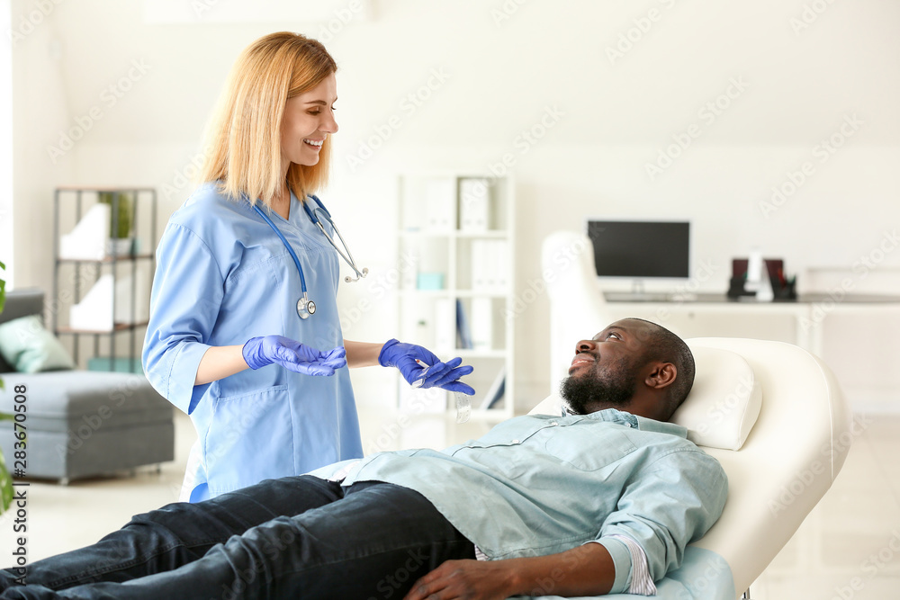 African-American man meeting with plastic surgeon in clinic