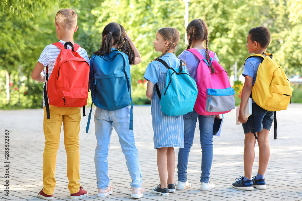 Group of cute little pupils outdoors