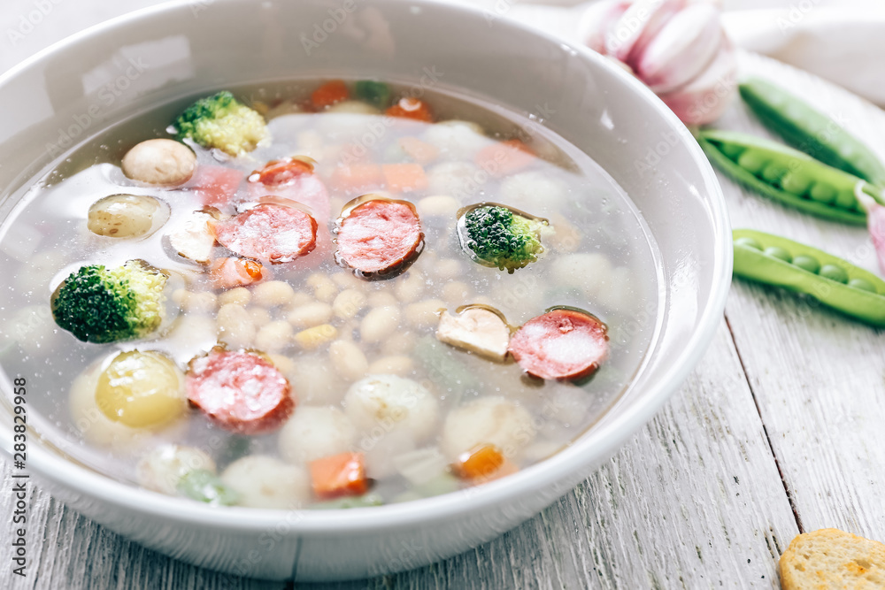 Tasty soup with legumes in bowl on table, closeup