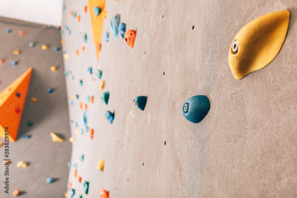 Wall with climbing holds in gym