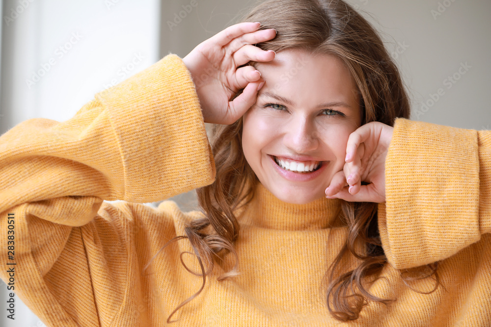 Portrait of happy young woman at home