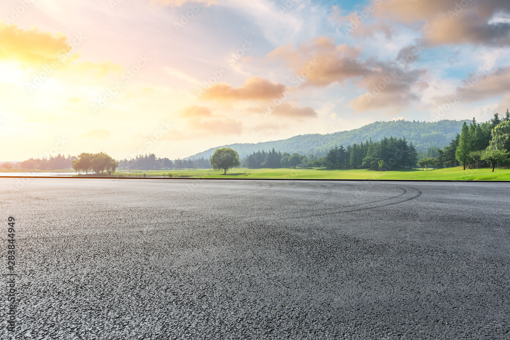 Wide race track and green woods nature landscape at sunset