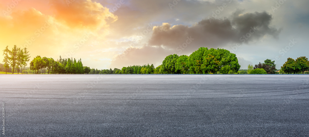 Empty race track and green woods nature landscape at sunset