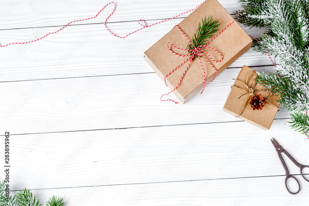 gifts boxes with fir branches on wooden background top view