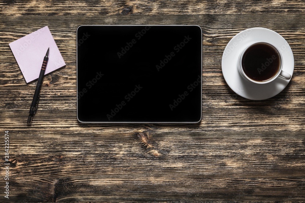 Workplace, laptop and tablet pc and phone on  table