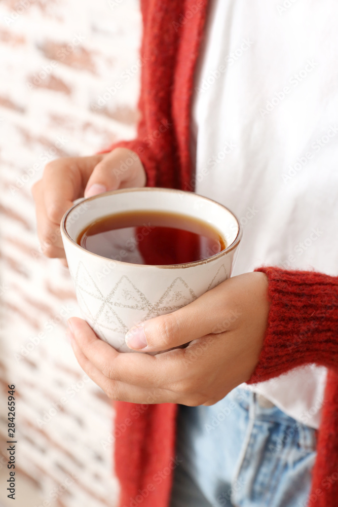 Woman holding cup of hot tea, closeup