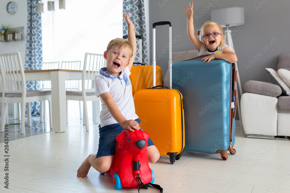 Kids with baggages ready to go for sun holidays