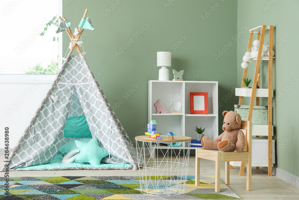 Interior of modern childrens room with teepee