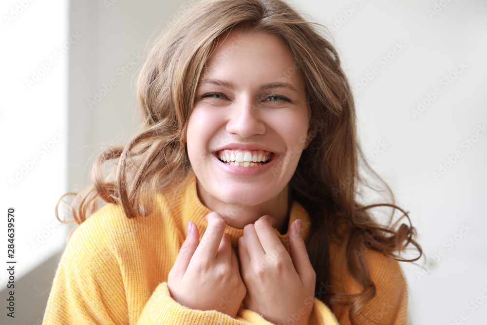 Portrait of happy young woman at home