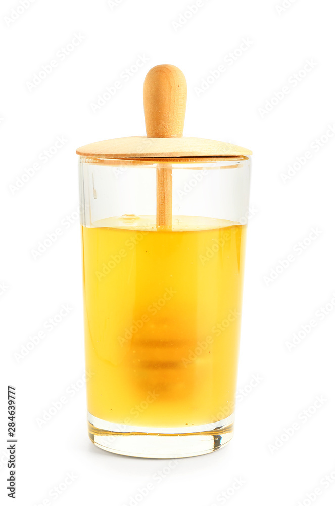 Glass container with fresh honey on white background