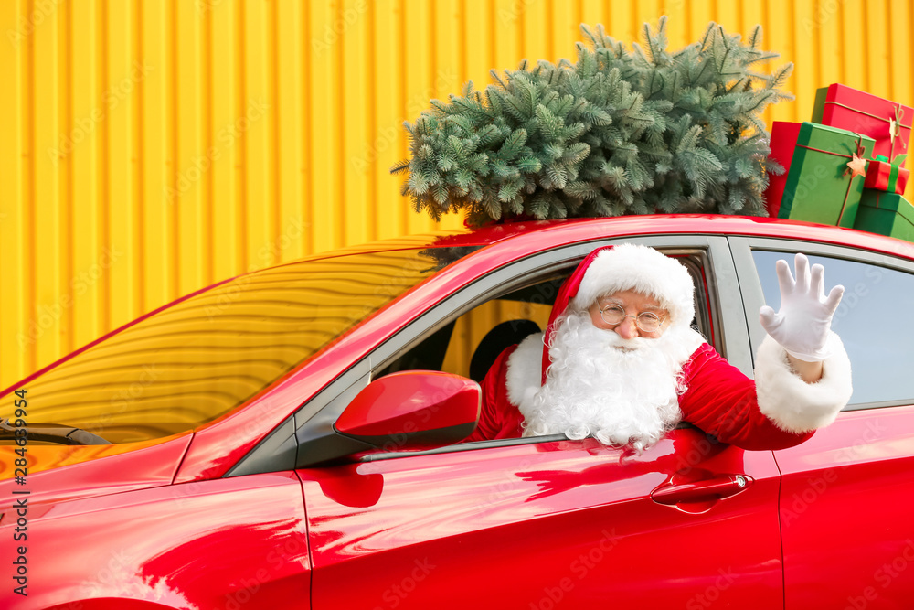 Santa Claus with gifts driving modern car