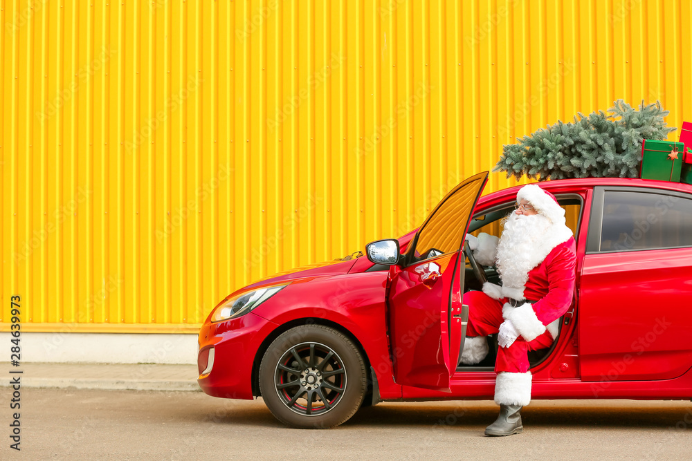 Santa Claus with modern car outdoors