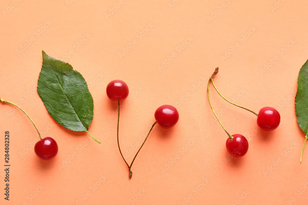 Ripe sweet cherry on color background