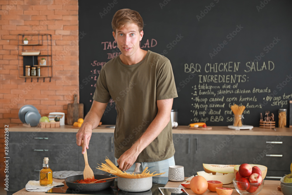 Handsome man cooking in kitchen