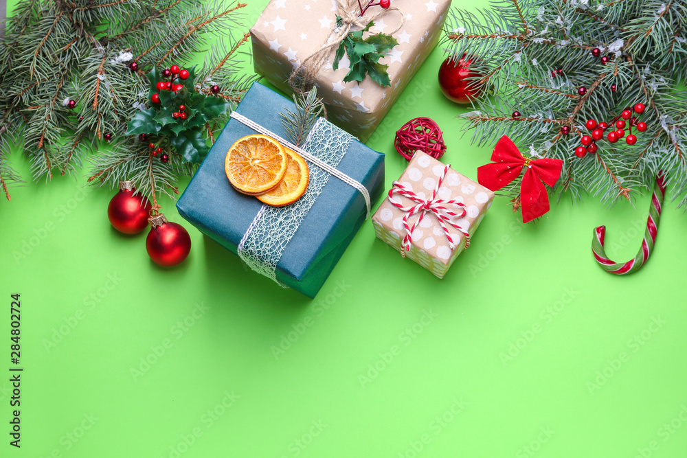 Christmas gift boxes with decor on color background