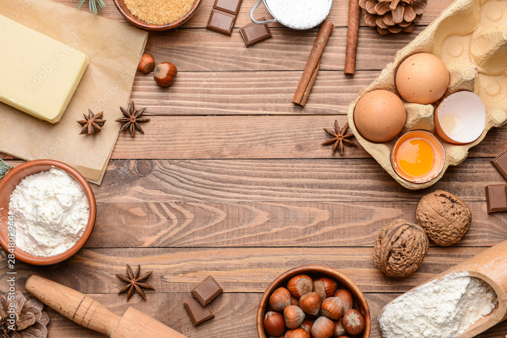 Frame made of ingredients for Christmas pie on wooden background