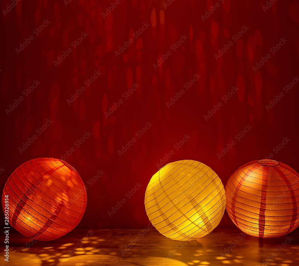 Beautiful retro colored paper lanterns hanging on a red background