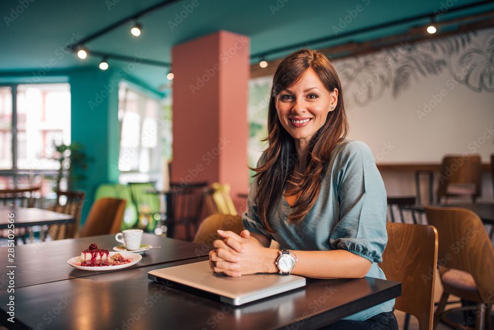 Portrait of a positive female entrepreneur at the bistro.