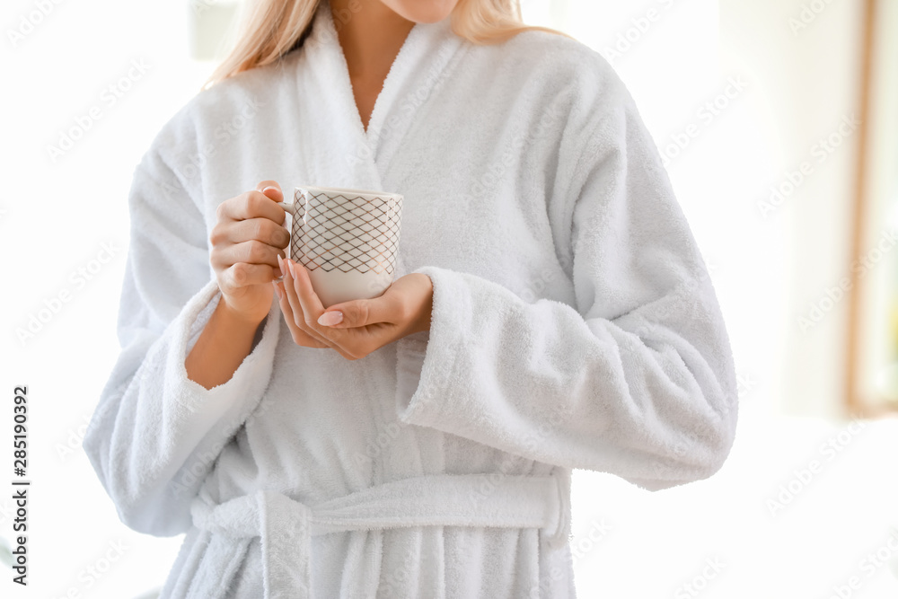 Morning of young woman drinking coffee at home, closeup