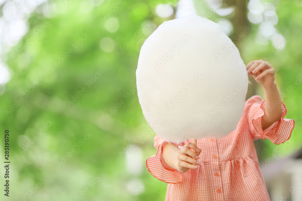 Woman with sweet cotton candy outdoors