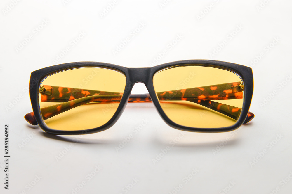 Stylish glasses on light background