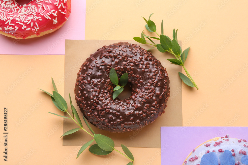 Sweet tasty donuts on color background