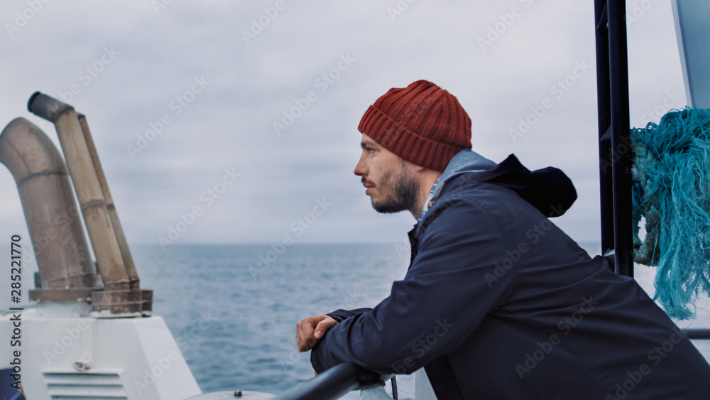 Serios Man Stands on the Ship and Looks At the Sea.